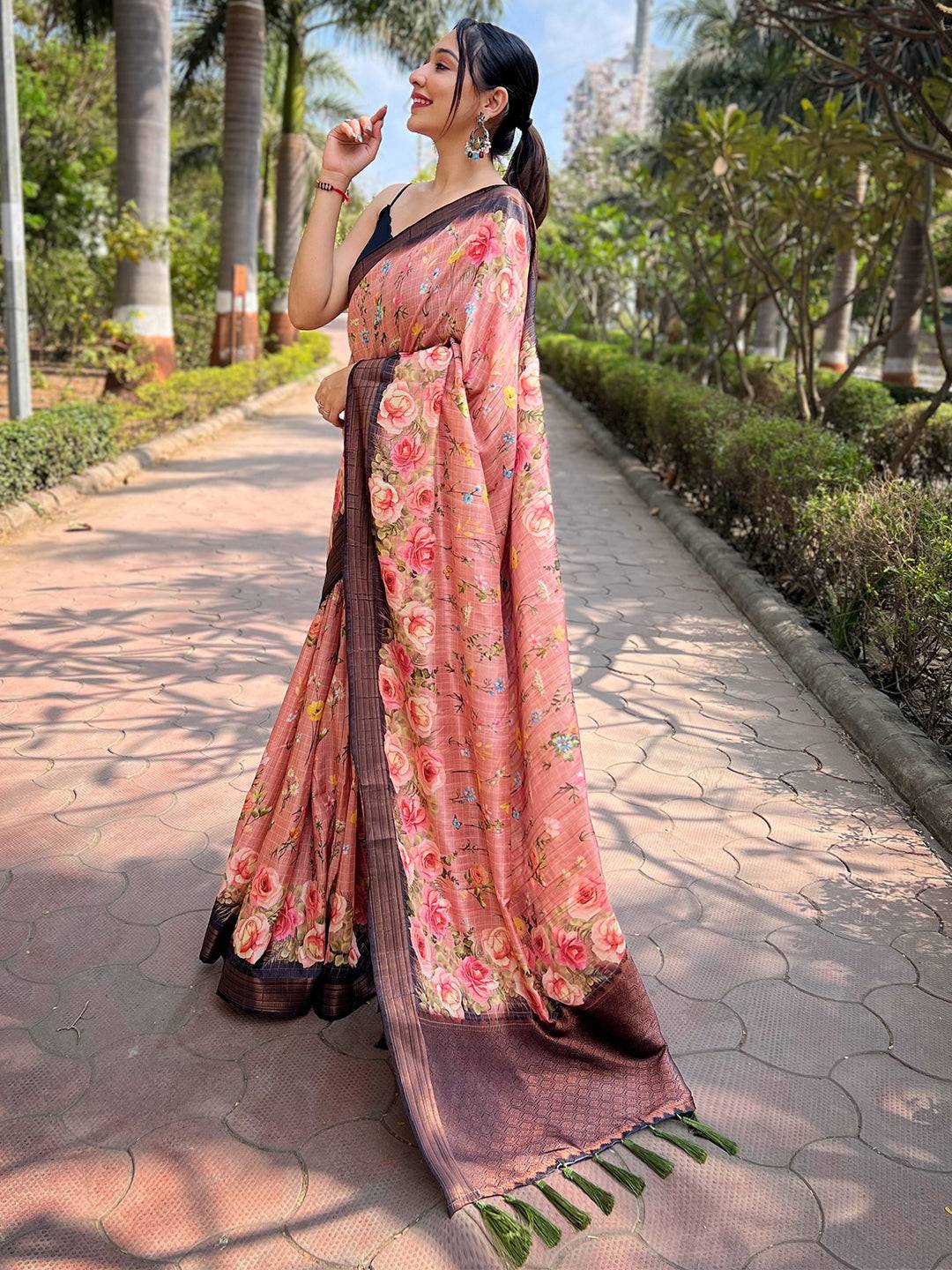 Model in peach silk saree, copper zari floral pattern, garden path