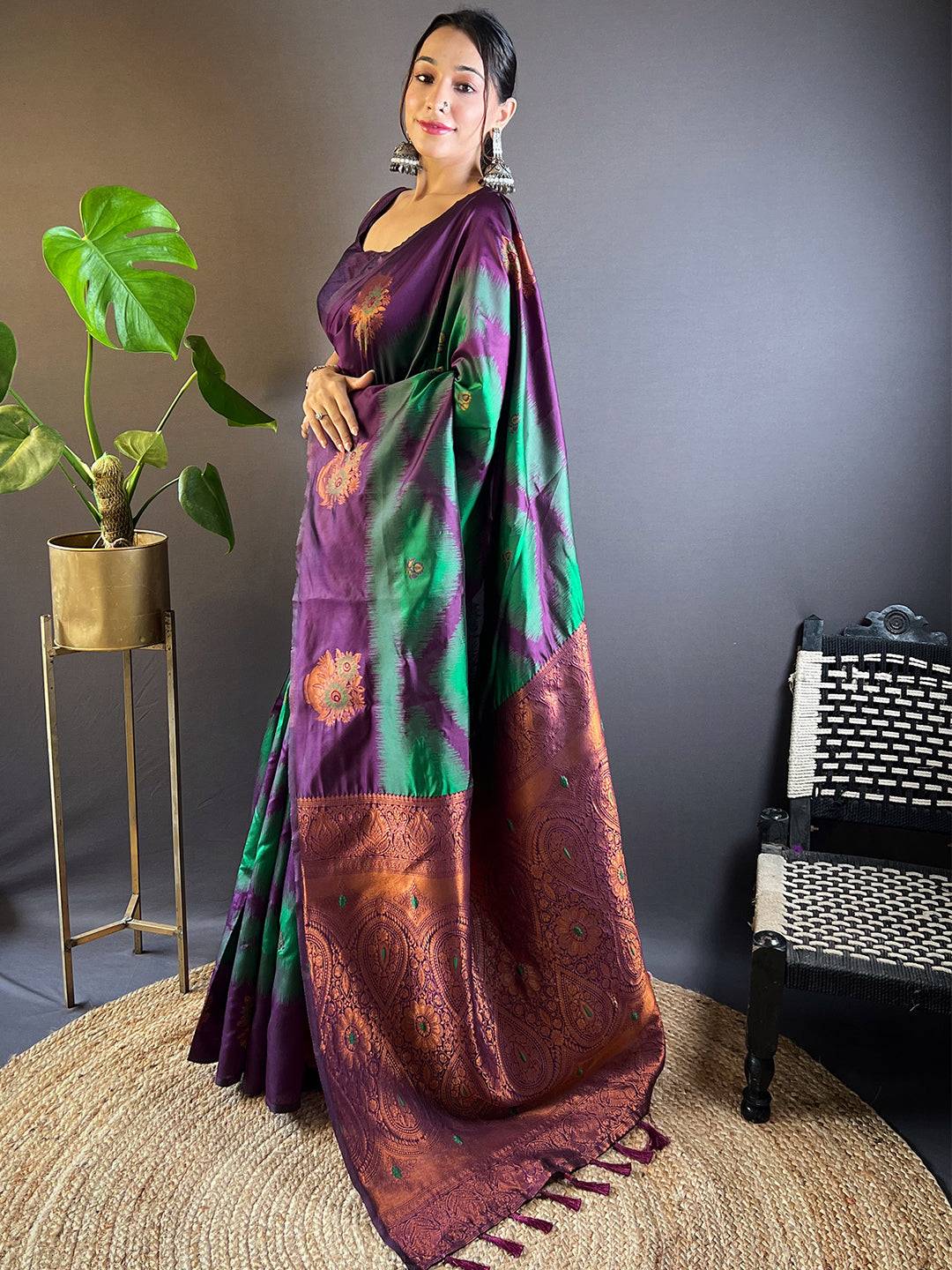 Side pose of model in dark green tussar silk Ikkat saree.