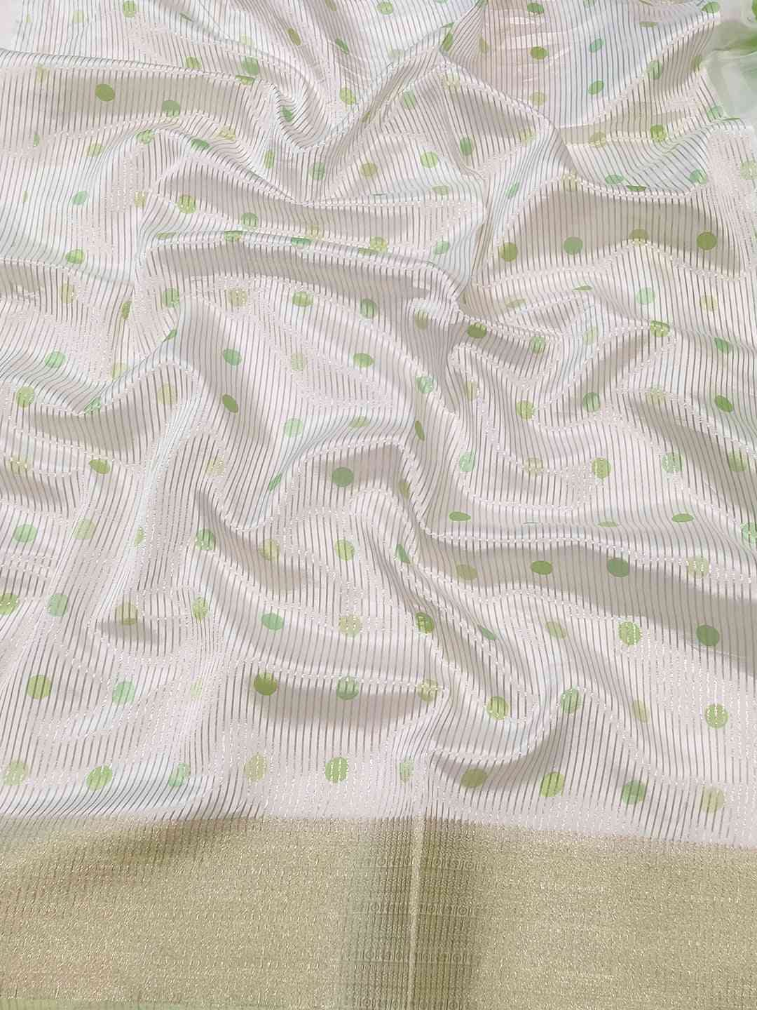 Detailed view of organza saree with green polka dots