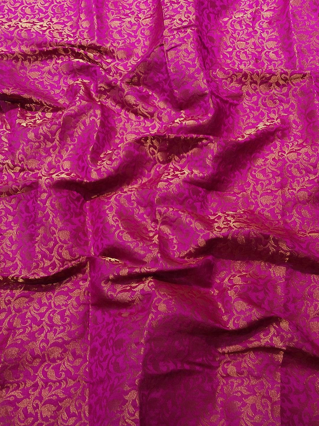 Close-up of pink brocade fabric with gold self-weaving design