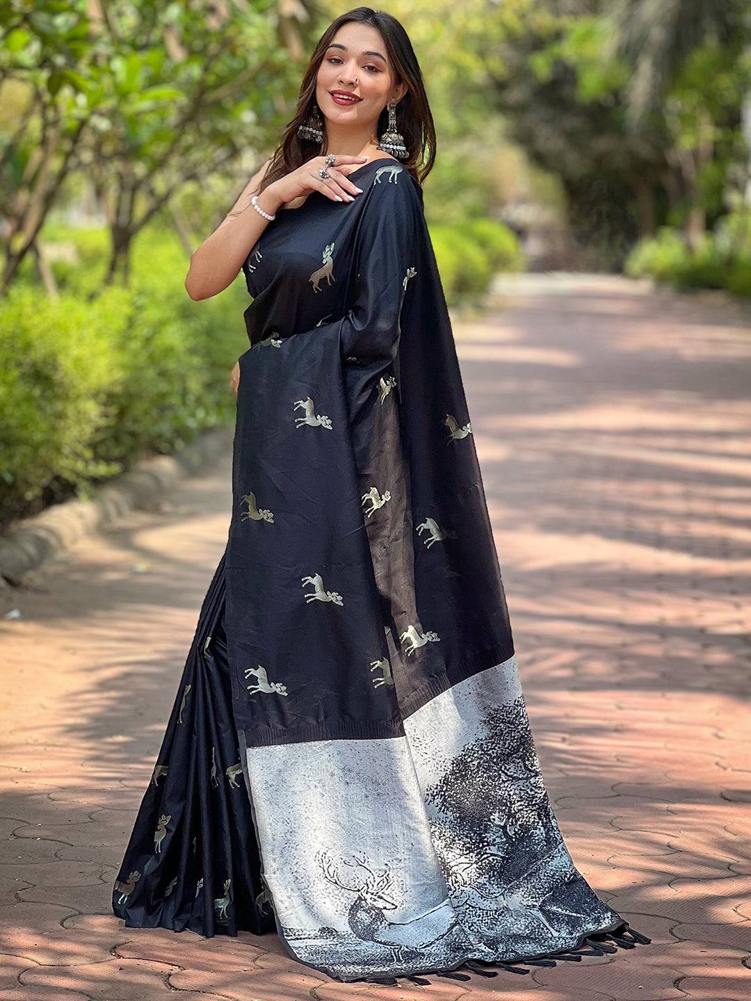 Model showcasing black silk saree with intricate zari pallu