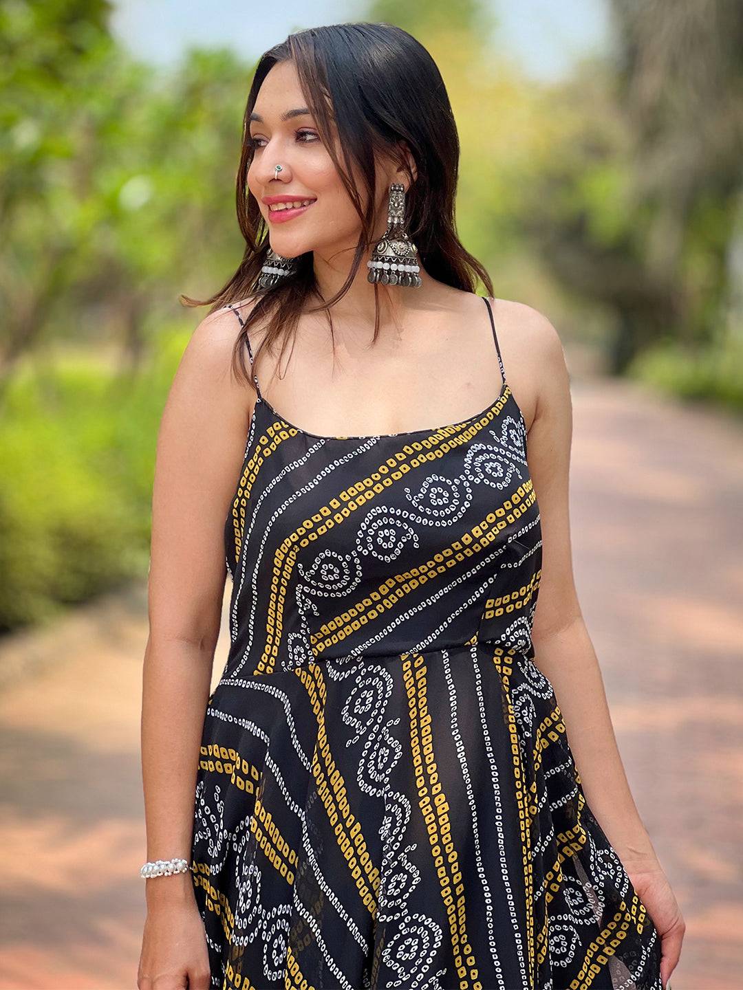 Close-up of Raven Black Bandhej Dress with silver earrings