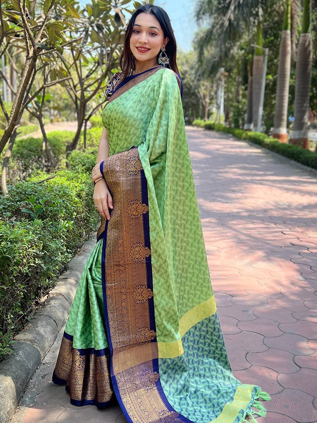 Side pose of woman in green Kanjivaram silk saree outdoors