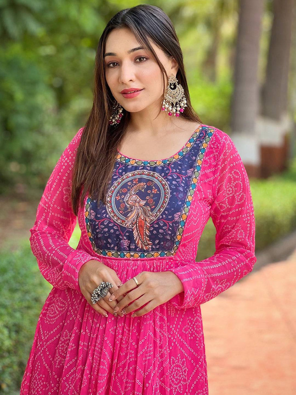 Model wearing deep pink Bandhej dress with detailed neckline.