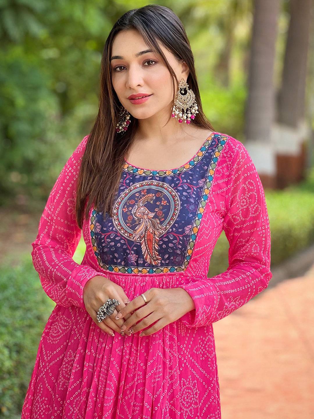Model wearing deep pink Bandhej dress with detailed neckline.