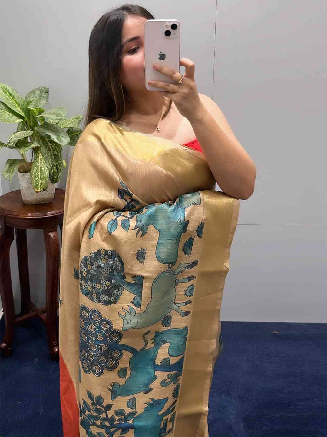 Close-up of Kalamkari linen tissue saree with artistic motifs.