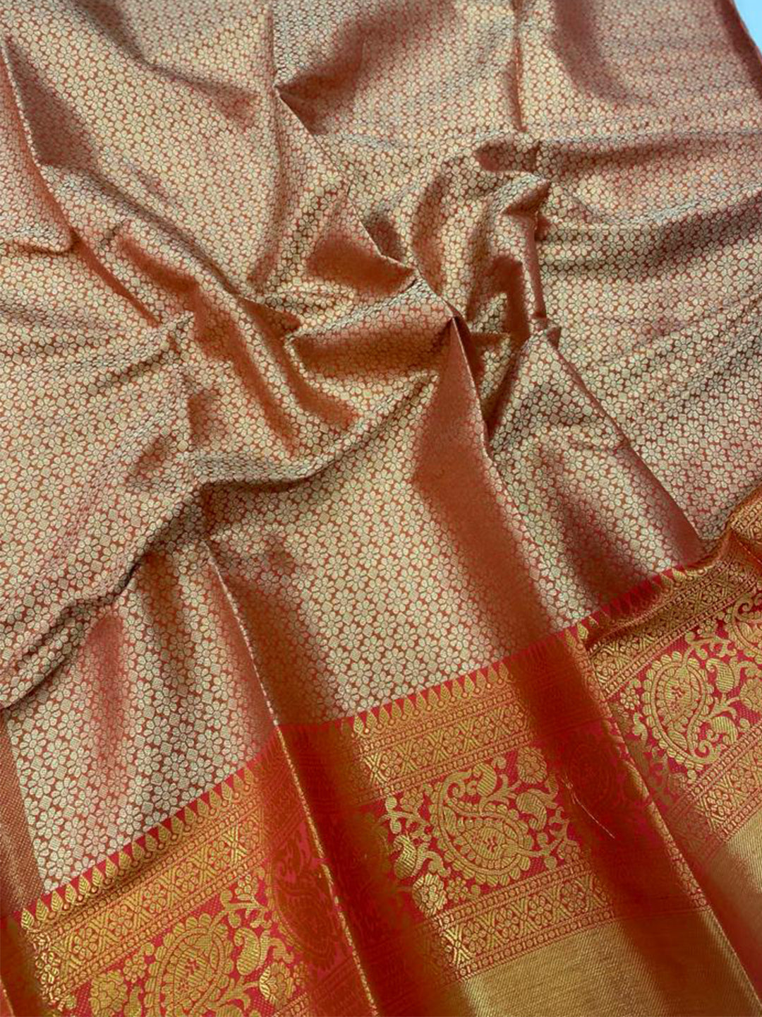 Close-up of gold zari Kanjivaaram pattu silk saree fabric.