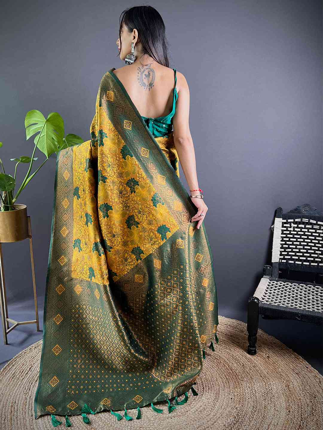 Back view of mustard silk saree with green floral butta weaving.