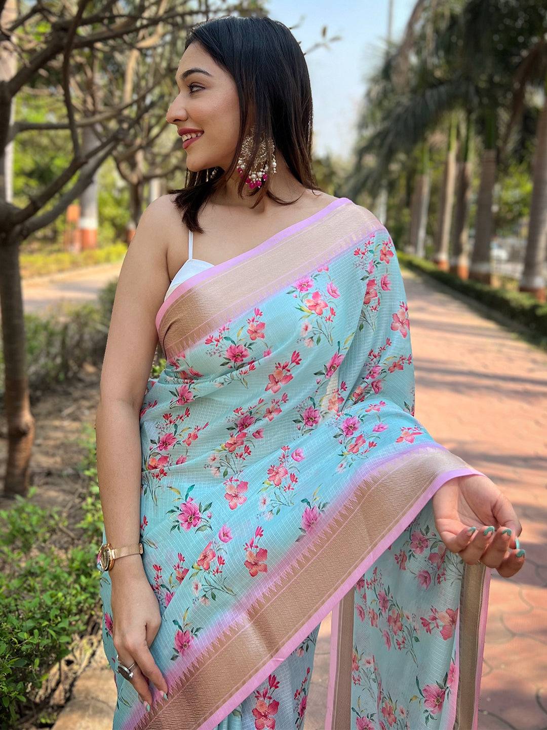 Close-up of Aqua Kota saree with digital floral print and pink border