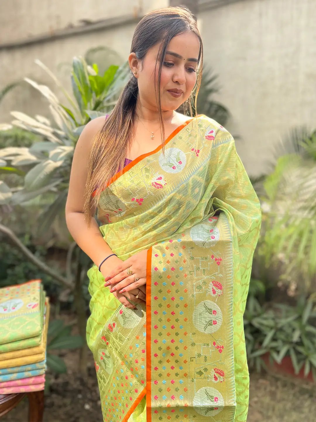 Woman wearing green Kota Doria silk saree with Minakari weaving