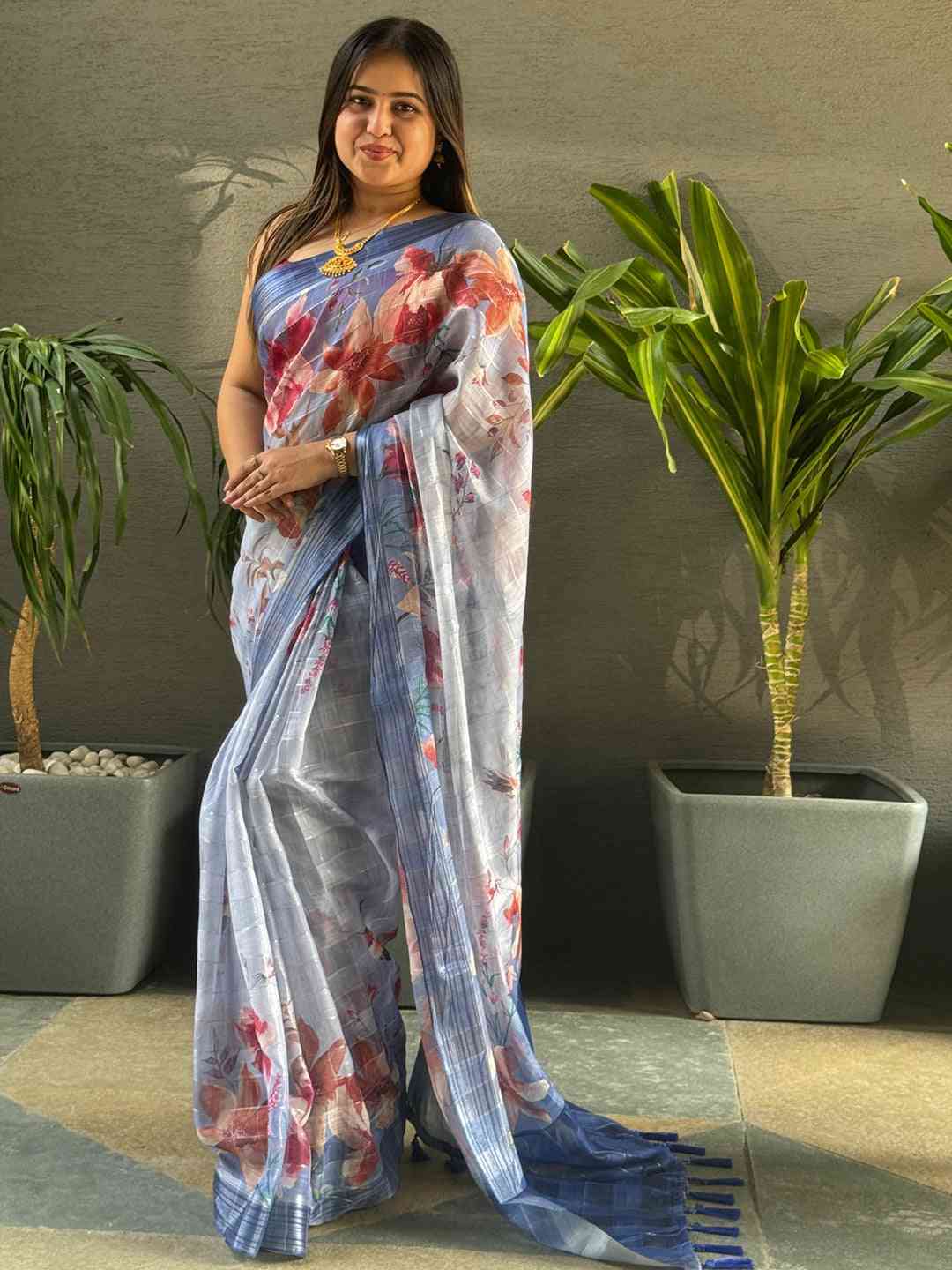 Traditional blue saree featuring floral print and zari chex.