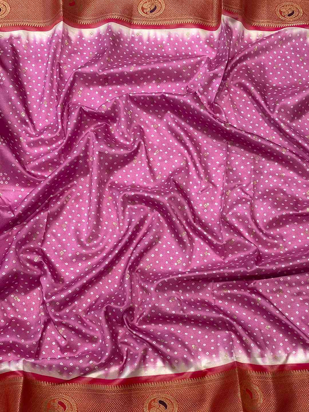 Close-up of purple Bandhani saree fabric with Paithani border