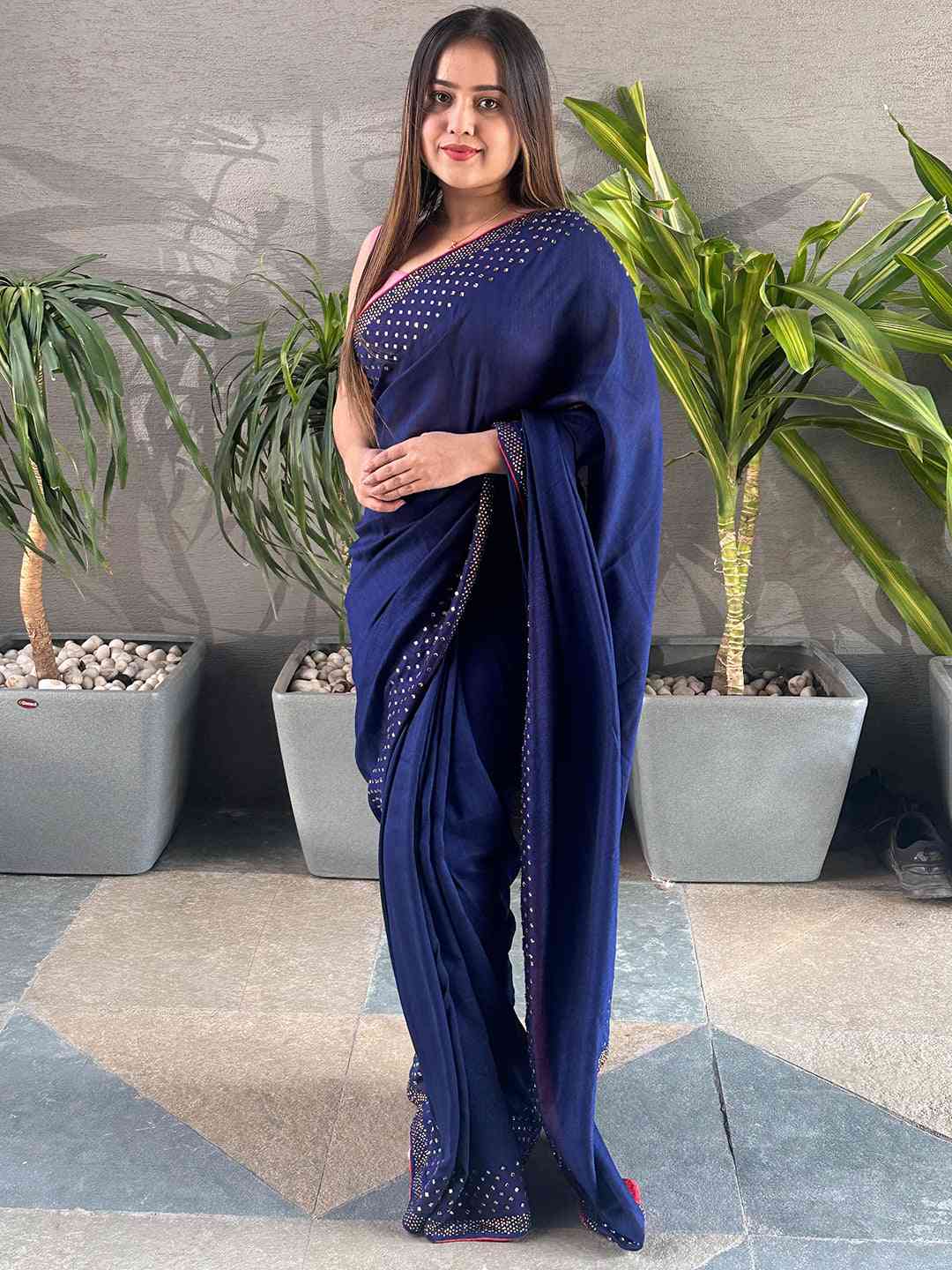 Elegant navy silk saree with Swarovski embellishments.