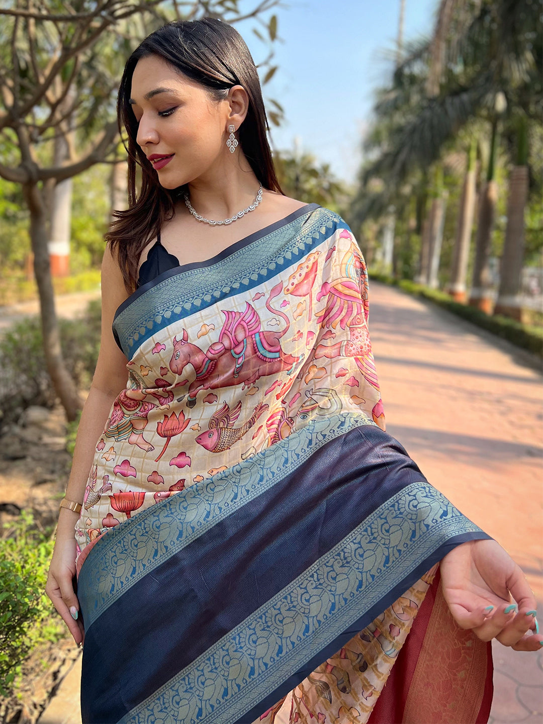 Model wearing Banarasi saree with floral and border motifs