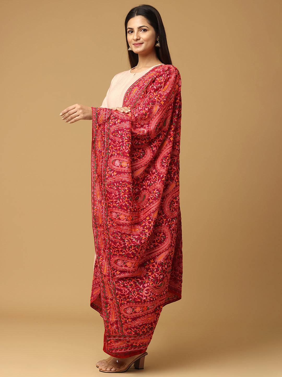 Side view of red dupatta highlighting paisley patterns.