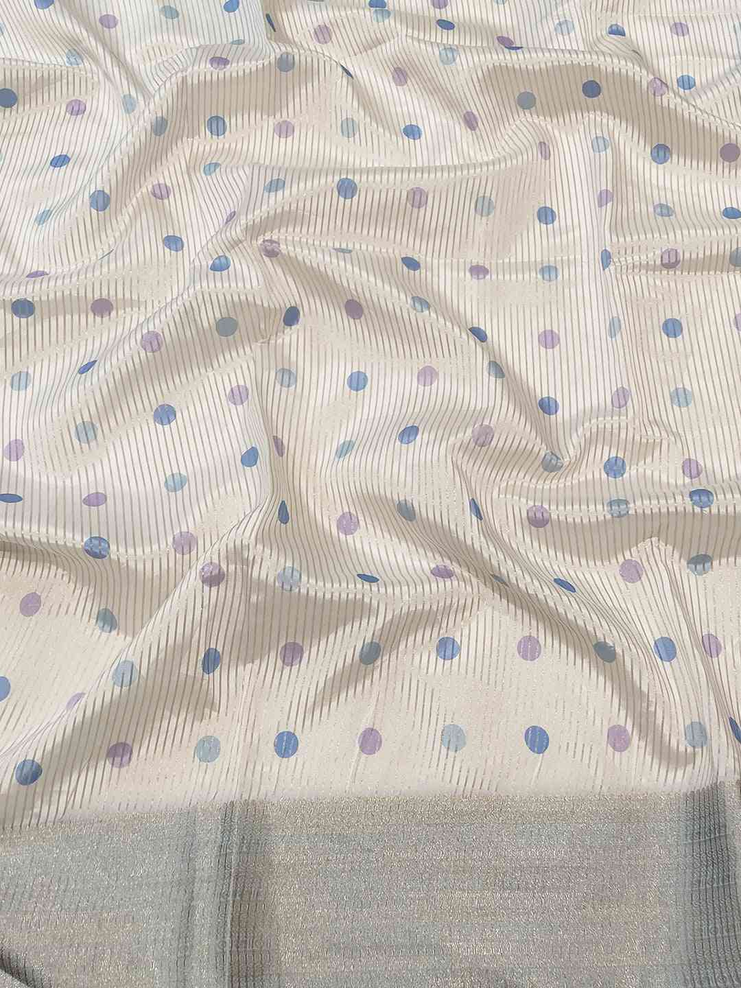 Close-up of Organza Saree fabric with polka dot design