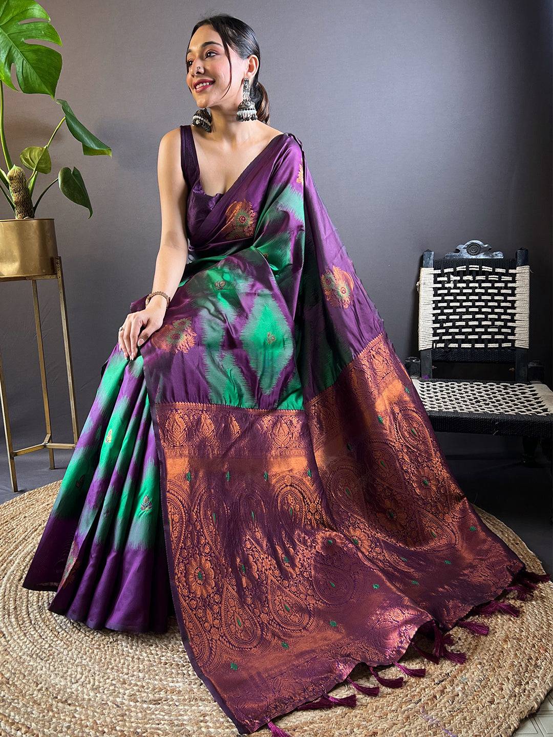 Model seated in dark green tussar silk Ikkat weaving saree.