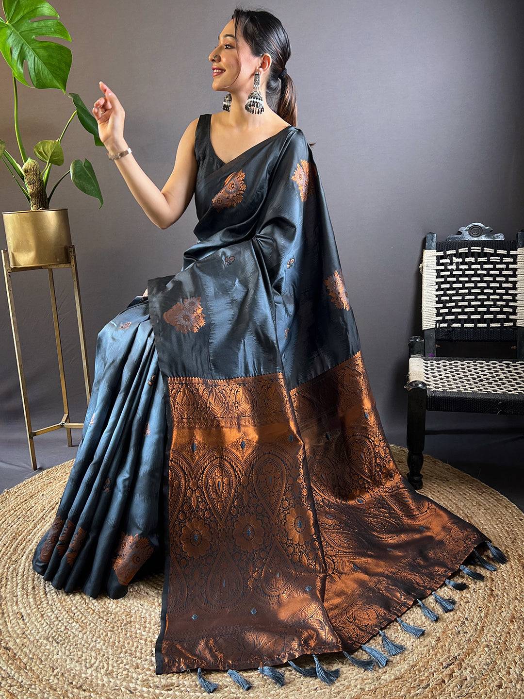 Seated model in Black Tussar Silk Ikkat Weaving Saree