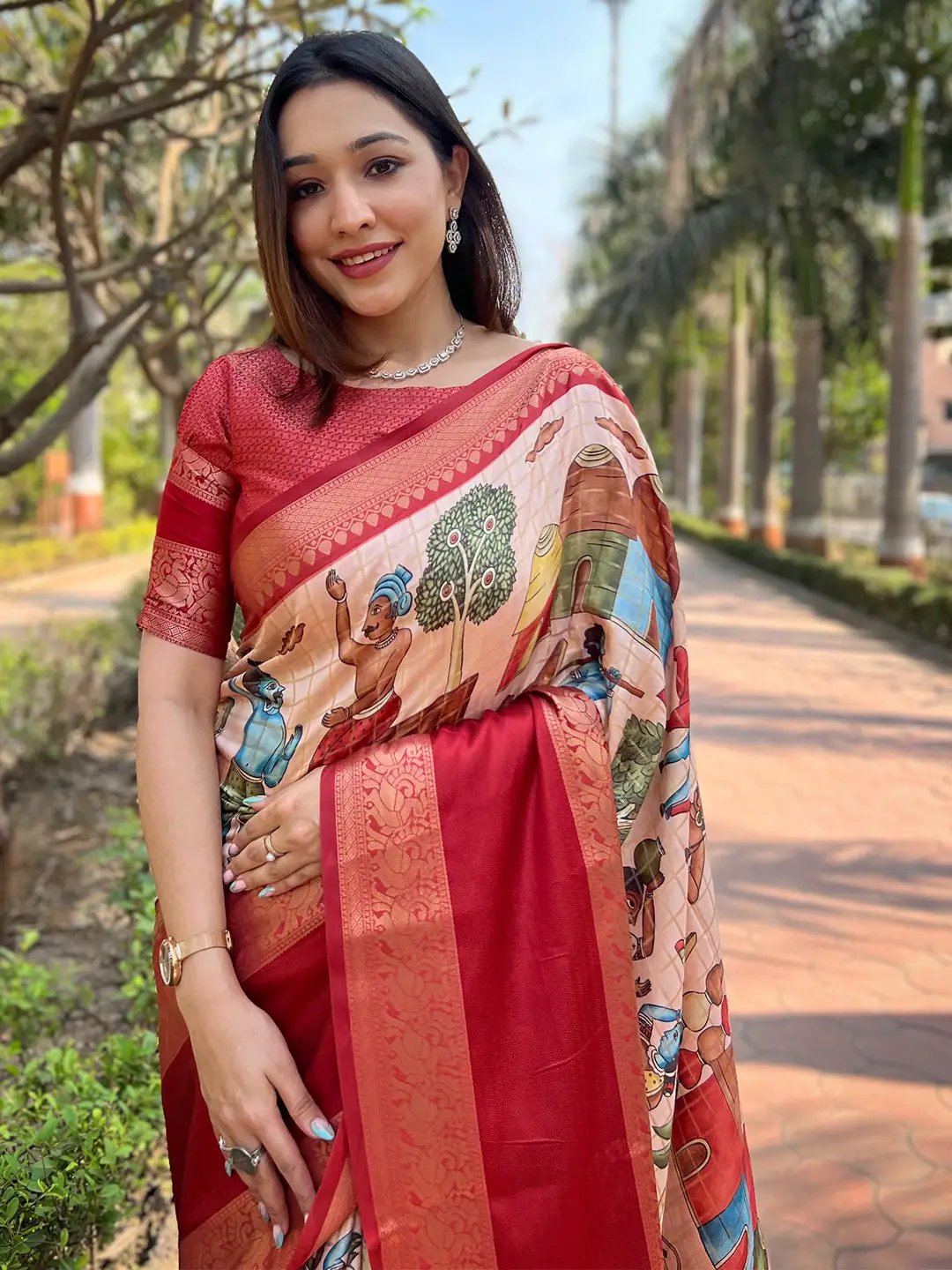 Woman in red Banarasi saree with cultural patterns