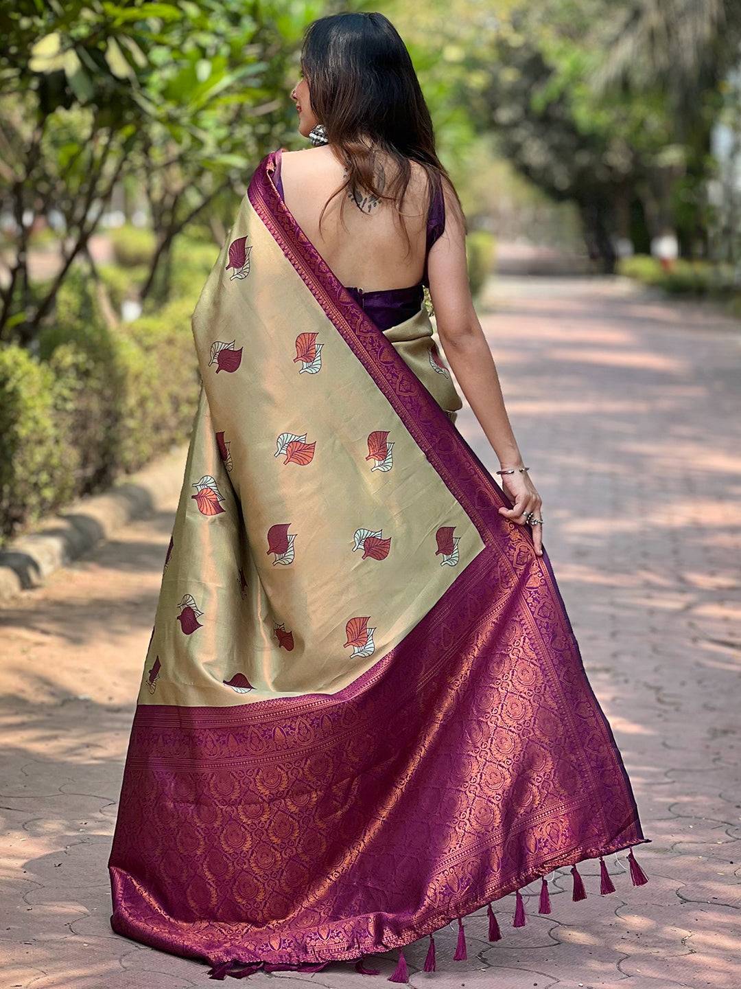Back view of light green saree with maroon pallu and leaf designs