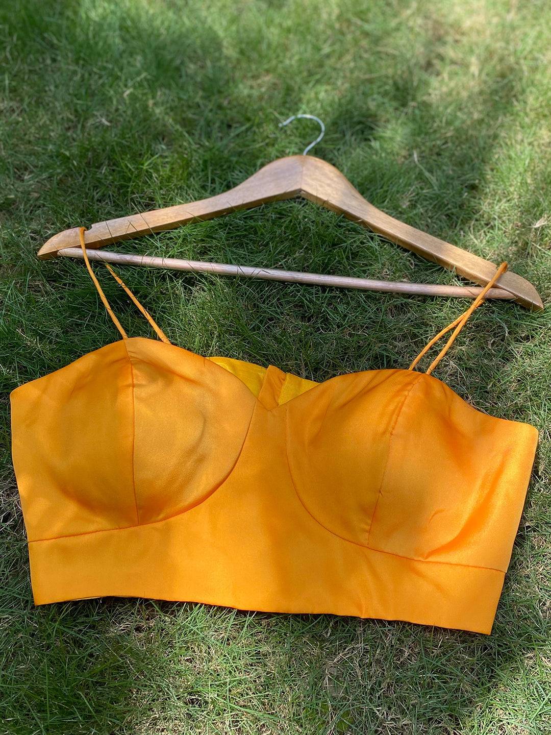 Yellow spaghetti strap blouse on hanger