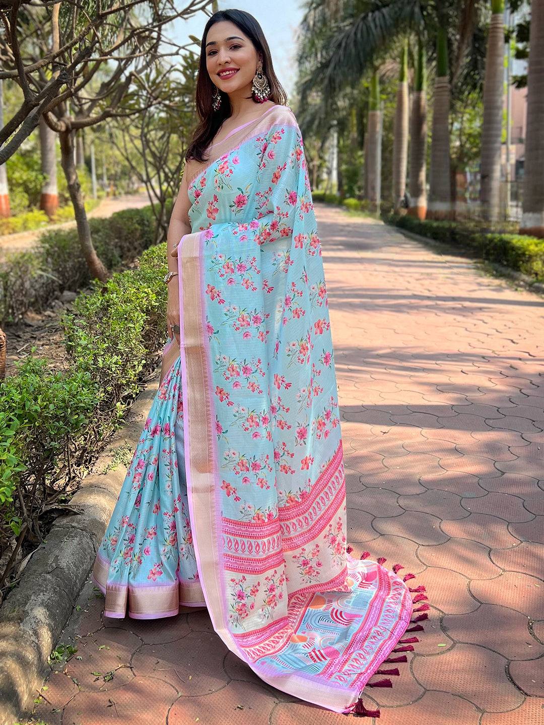 Woman in Aqua Kota saree with digital floral design on a path