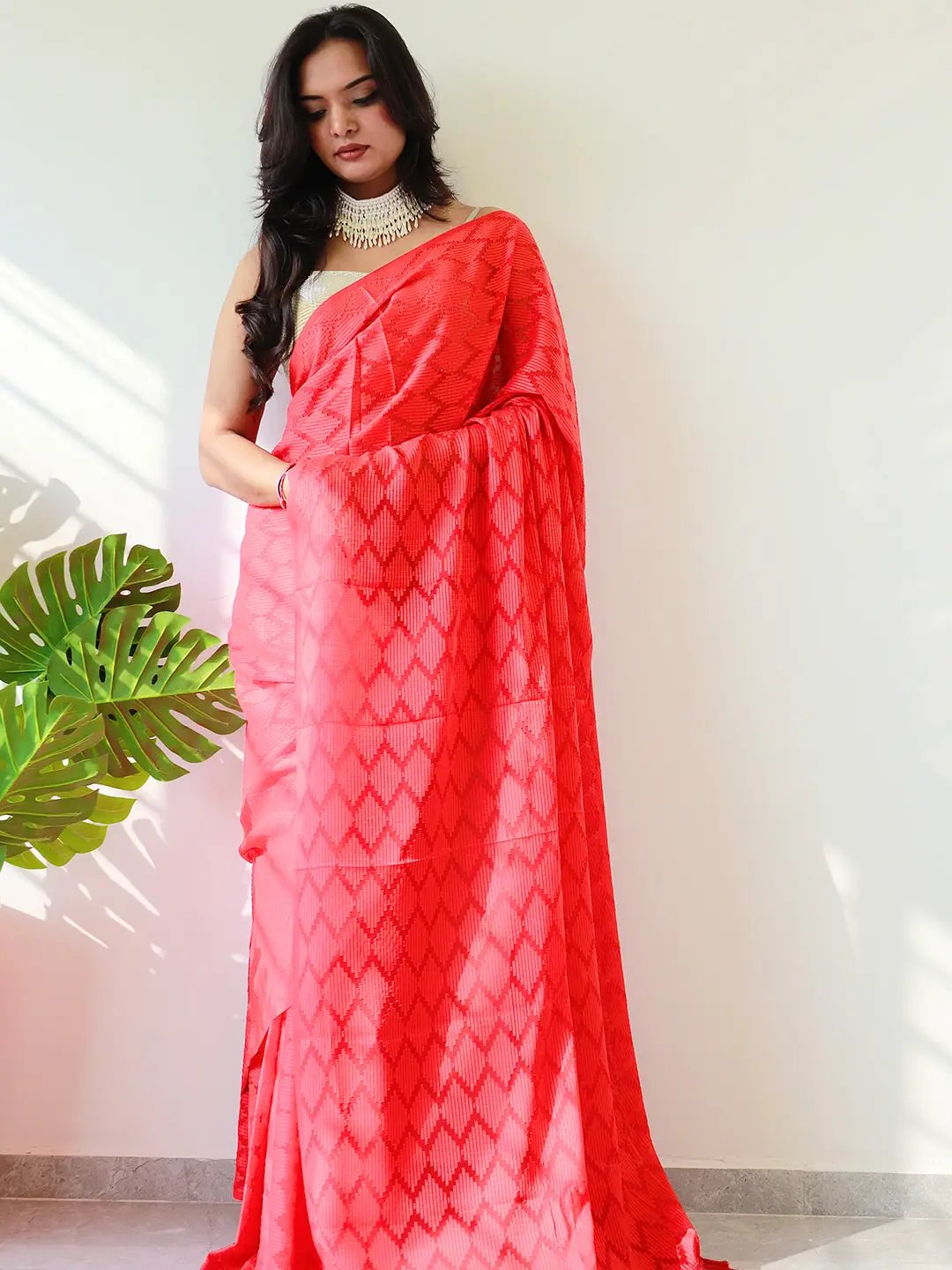 Stylish red georgette saree showcasing intricate patterns