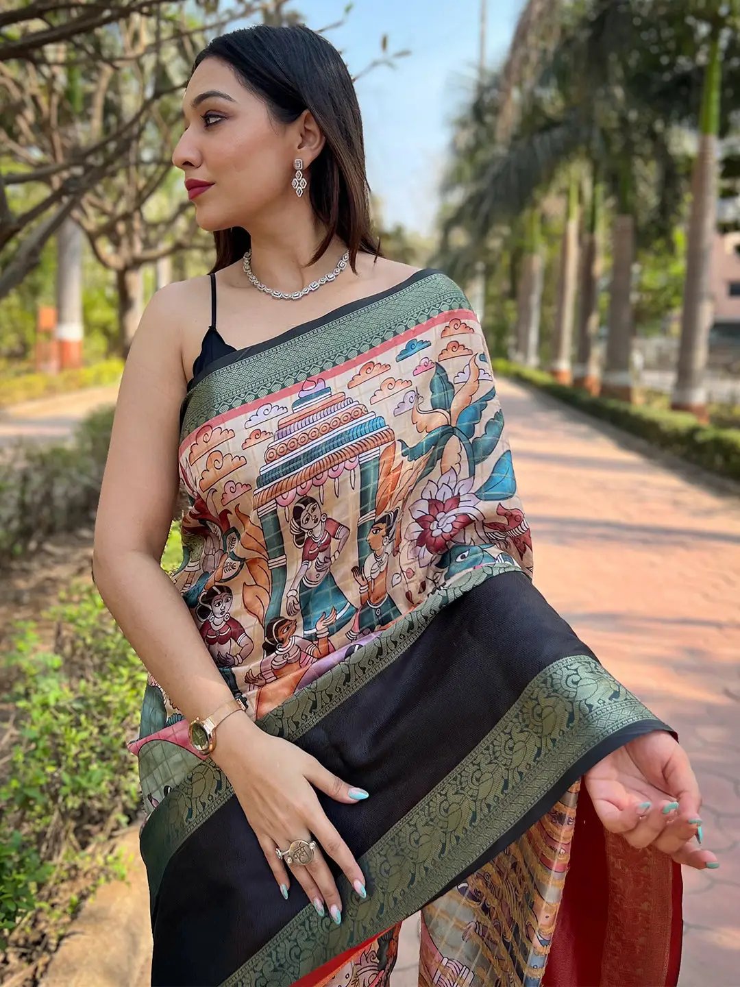 Close-up of Banarasi saree with vibrant patterns and green border