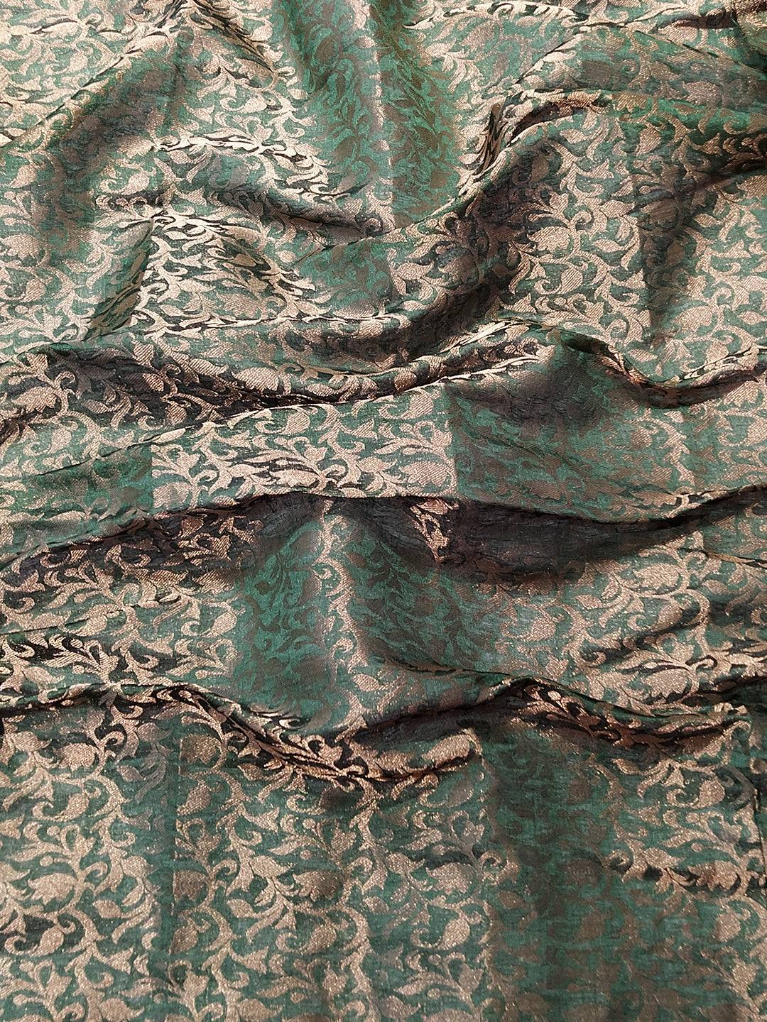 Close-up of green brocade blouse fabric with self-weaving