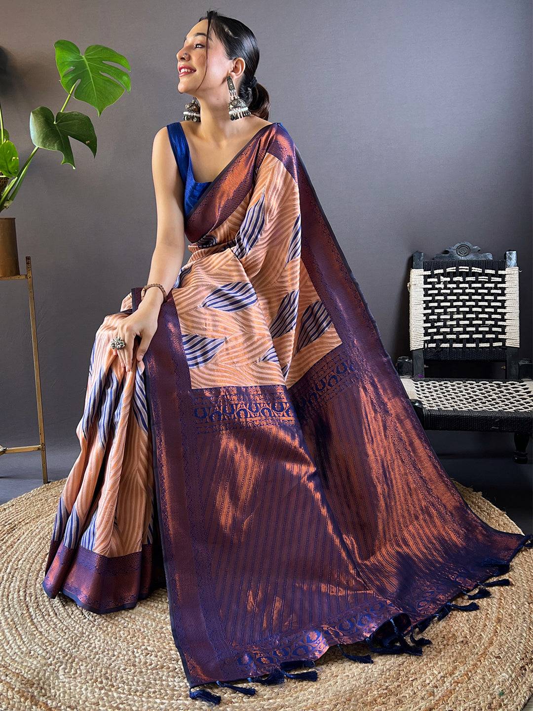 Model sitting in Peach Tussar Silk Abstract Print Saree