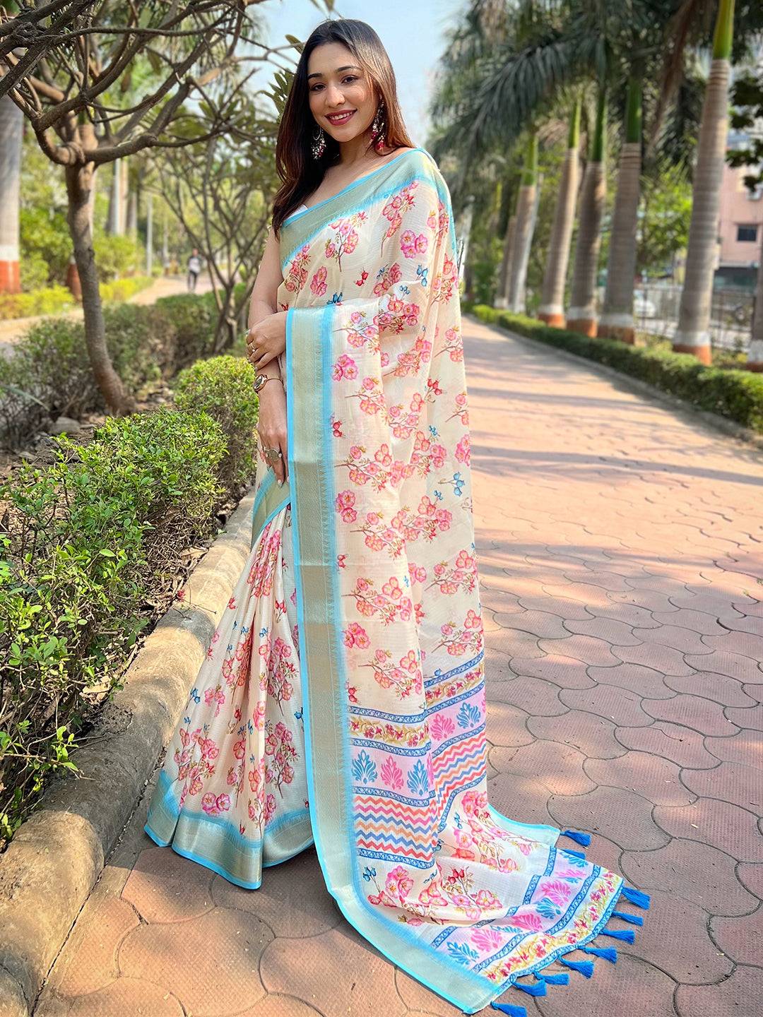Elegant Cream Kota saree with floral design, outdoor setting