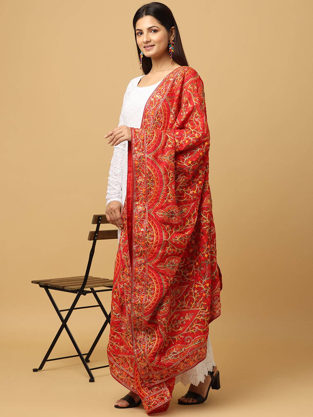 Model wearing red poly chiffon pashmina dupatta with motifs.