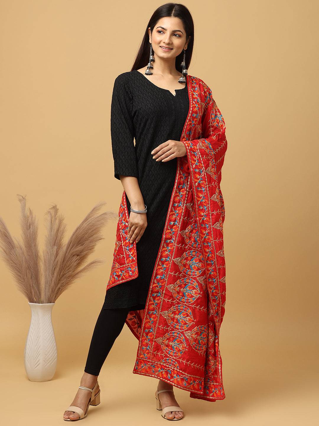 Model wearing red pashmina dupatta with ethnic motifs