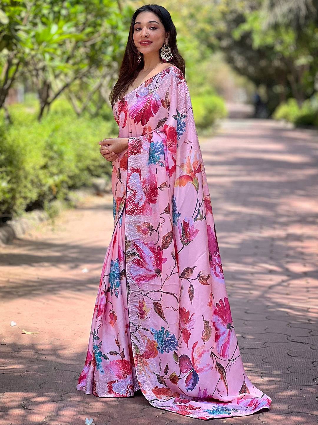 Model posing in satin georgette peach floral saree
