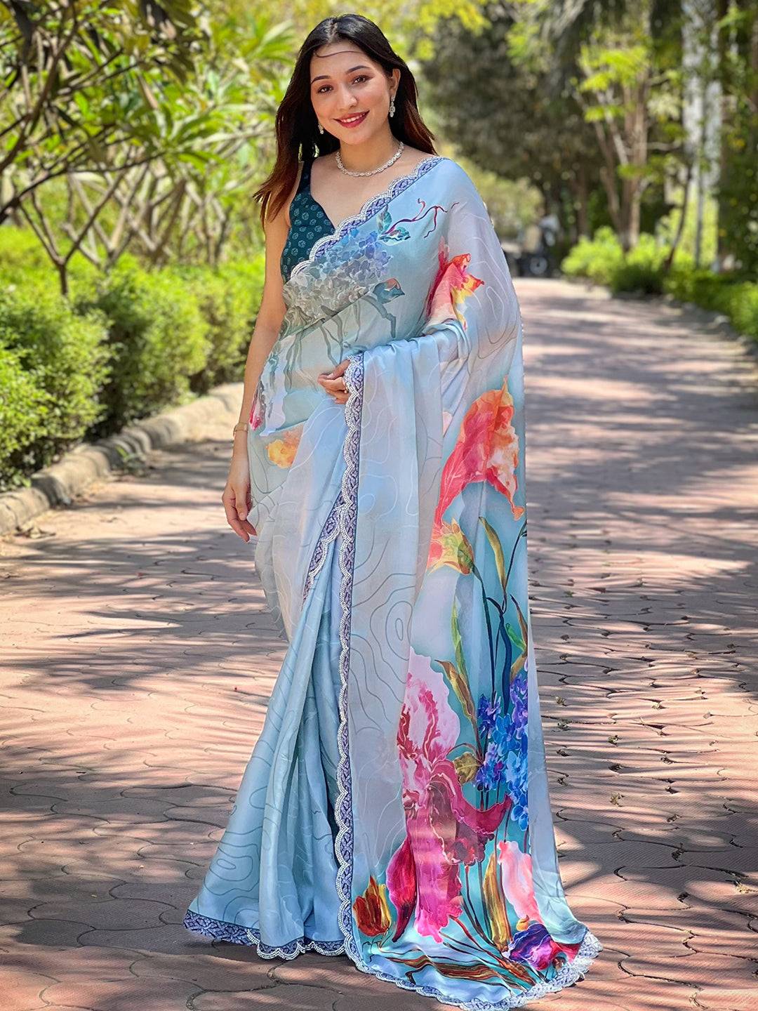 Model wearing light blue satin georgette floral saree
