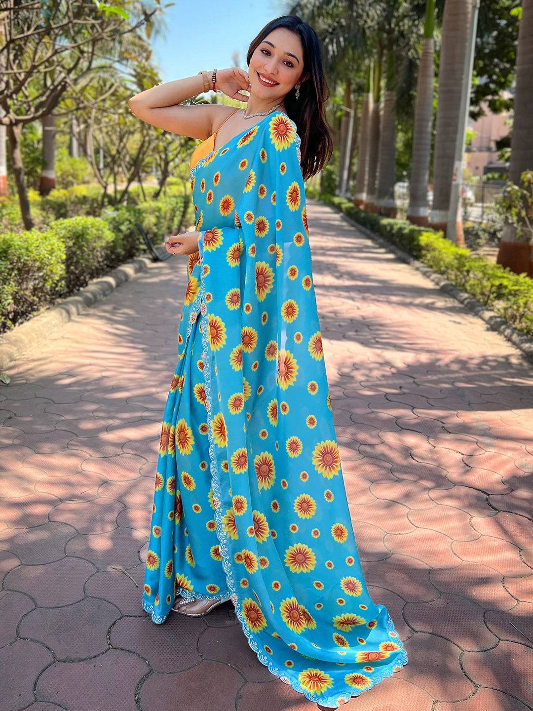 Elegant blue saree with sunflower design and Swarovski details