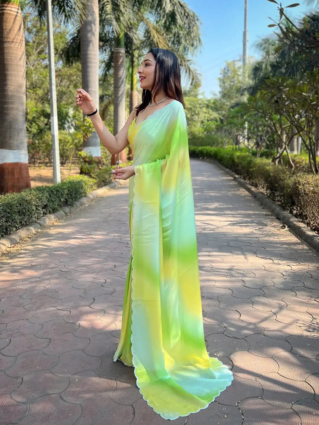 Side view of pista satin georgette saree in garden