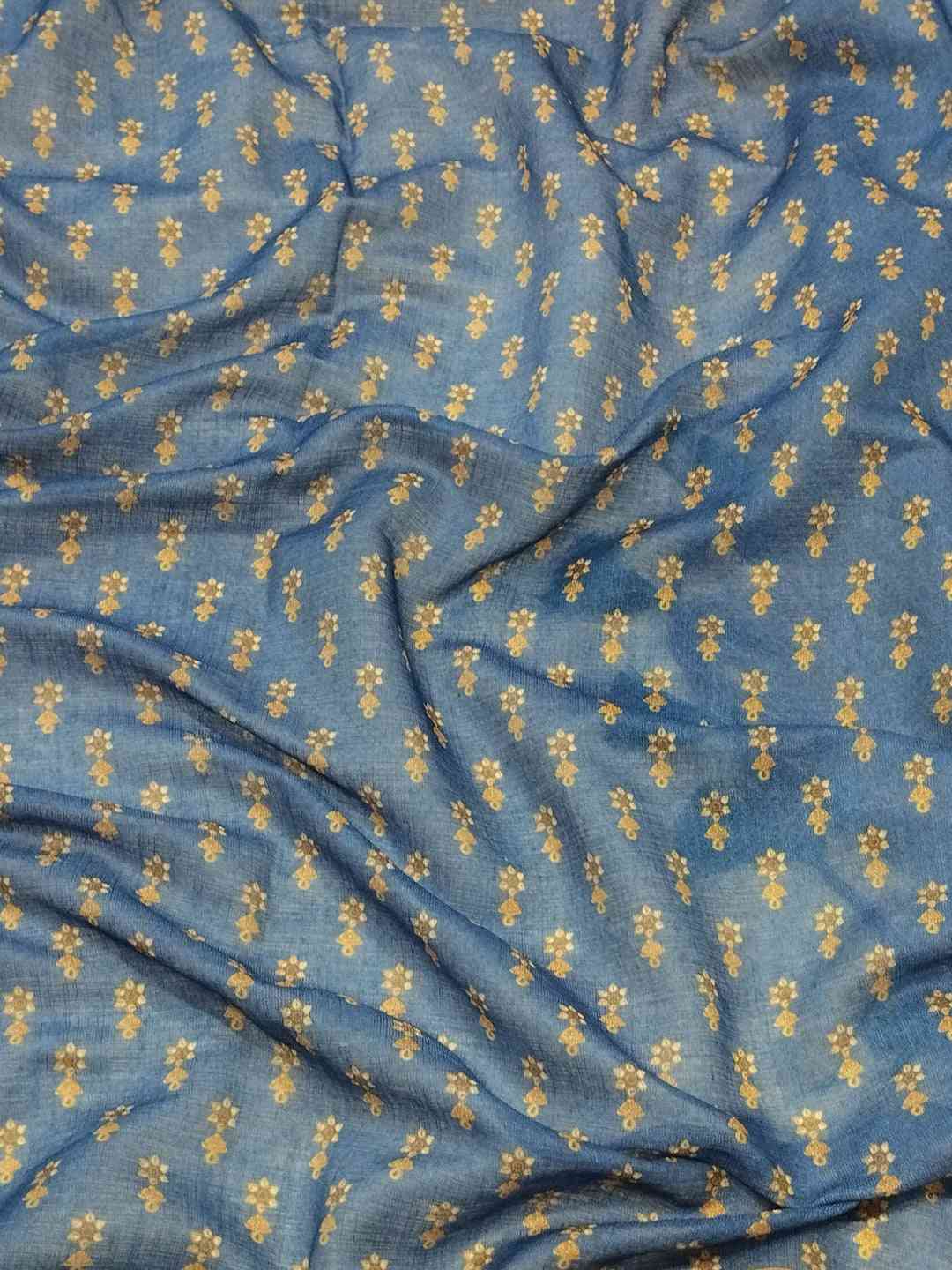Close-up of blue linen saree fabric with floral digital print