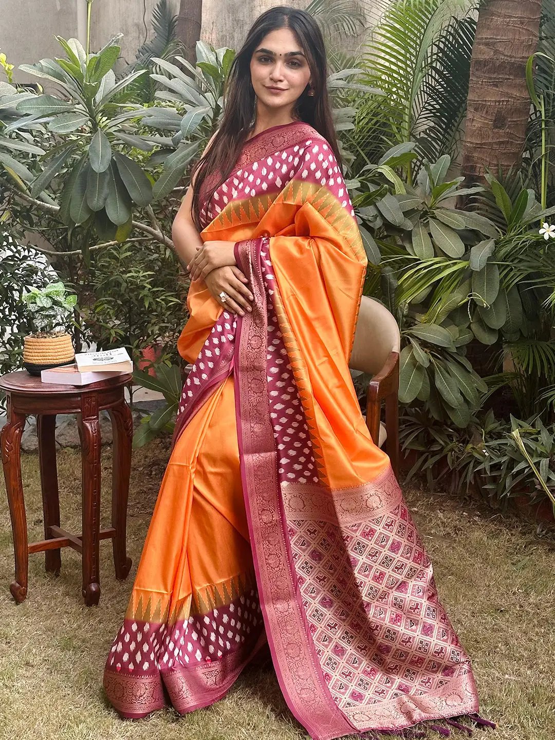 Elegant orange Banarasi silk saree with intricate Patola pallu