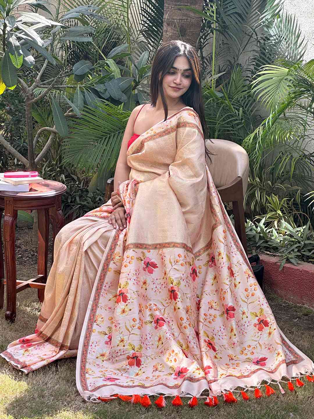 Peach Kanjivaram saree with floral design displayed outdoors