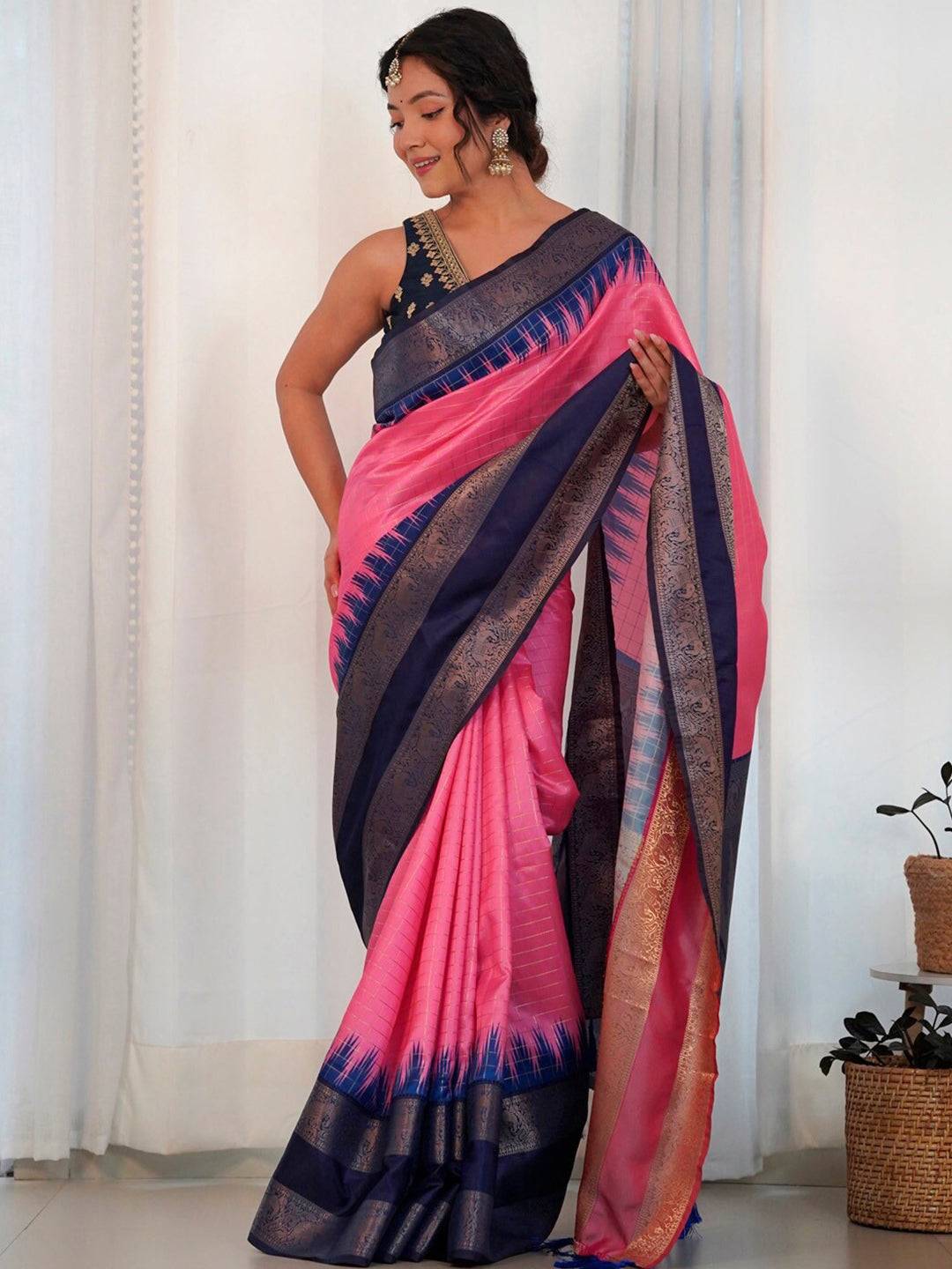 Model wearing pink Banarasi Gadwal saree with blue zari detailing