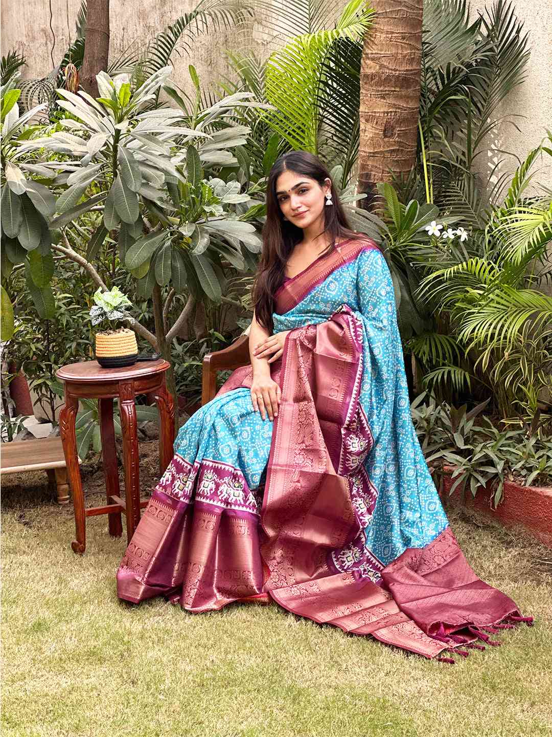 Turquoise Bandhej saree featuring a rich Pattu Zari border
