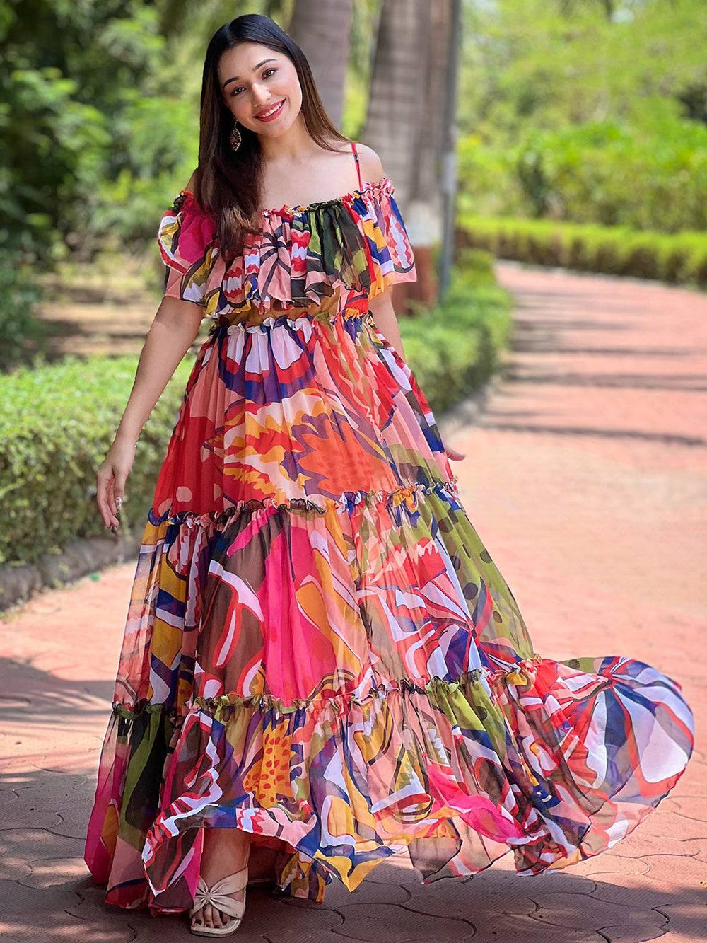 Woman in tropical printed off-shoulder maxi dress outdoors