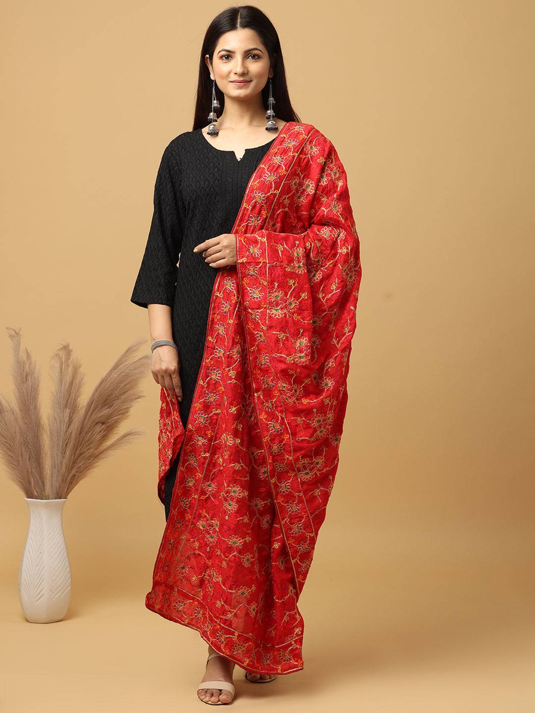 Model wearing red pashmina dupatta with intricate threadwork.