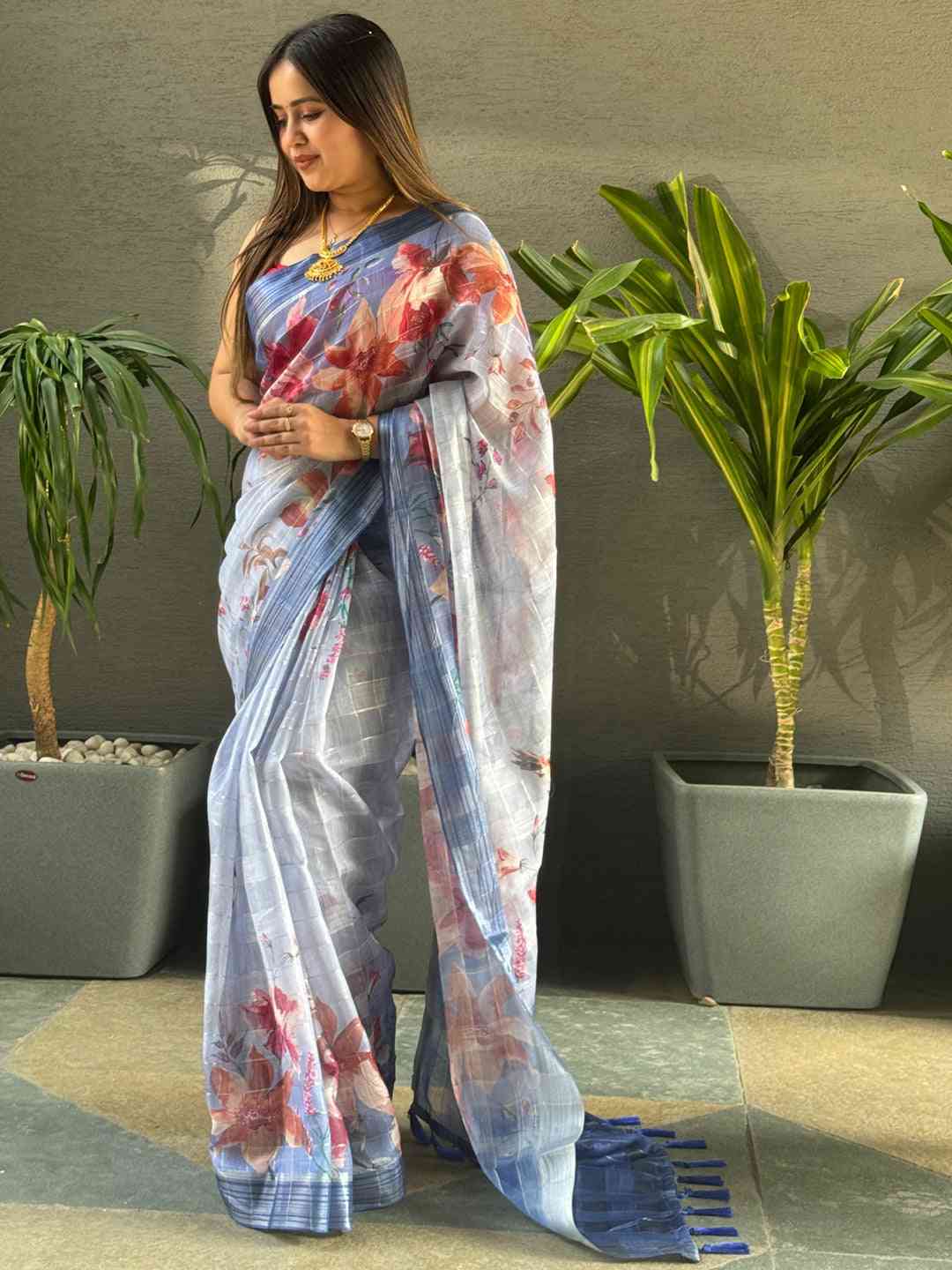 Blue floral print saree with traditional zari chex weaving.