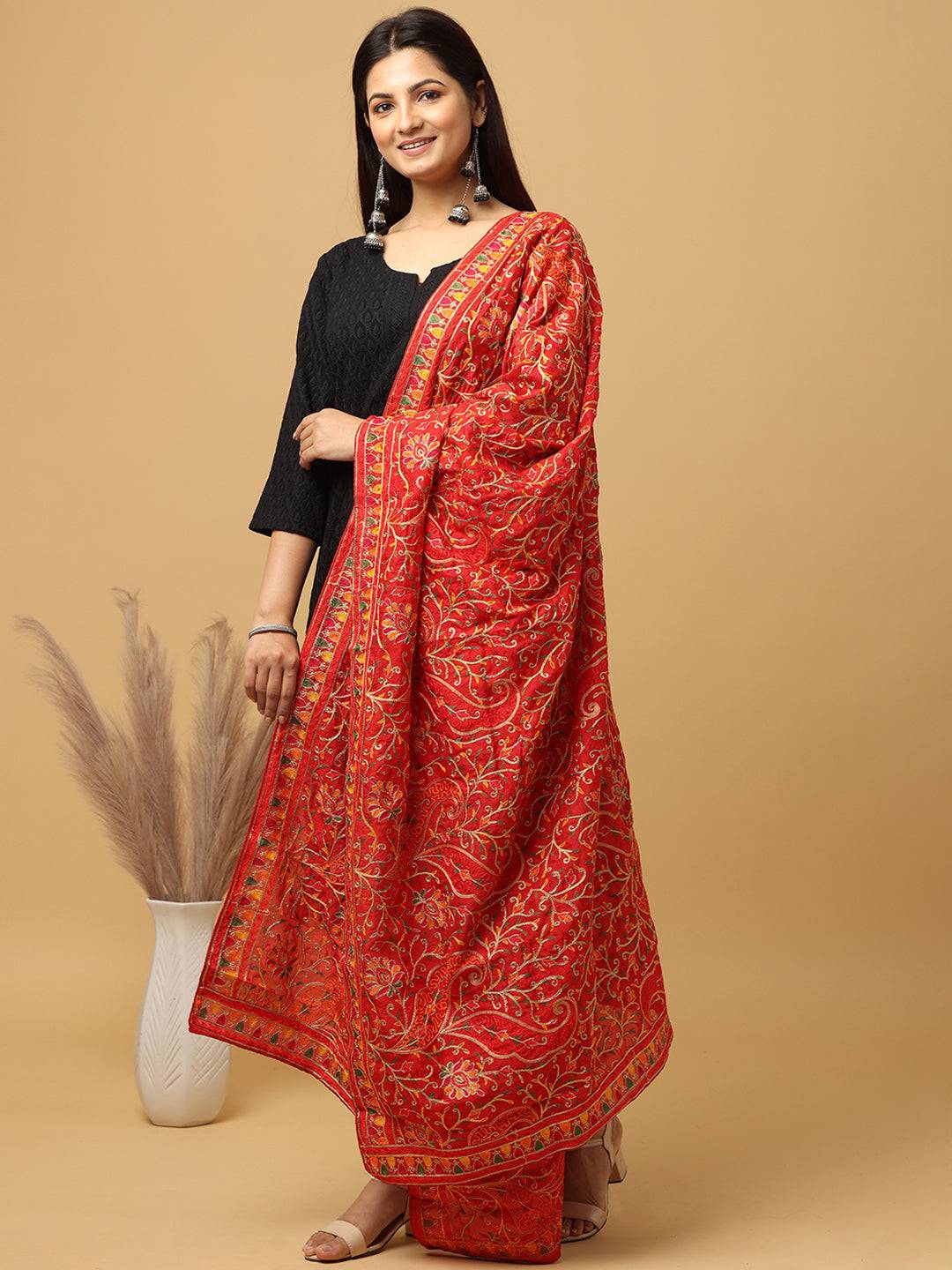 Model wearing red threadwork pashmina dupatta