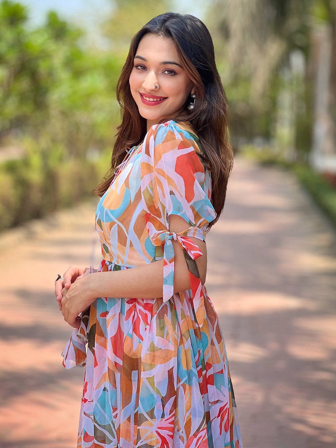 Side view of woman in rainbow abstract dress
