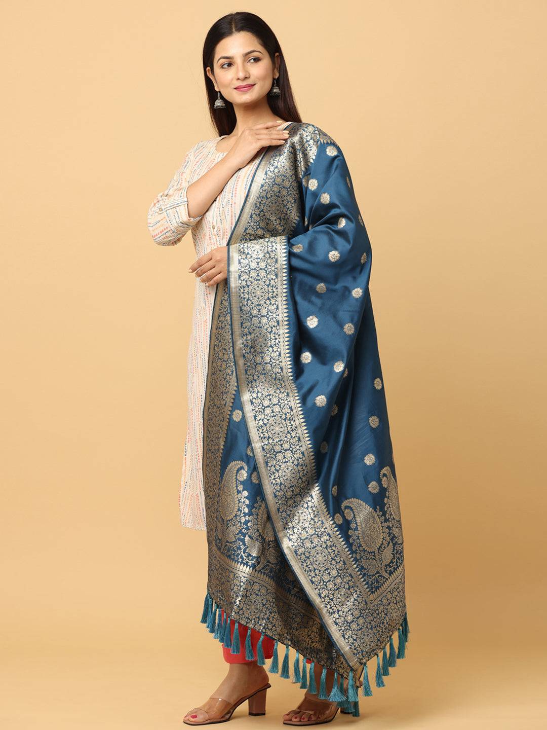 Model showcasing teal silk blend dupatta with ornate design.