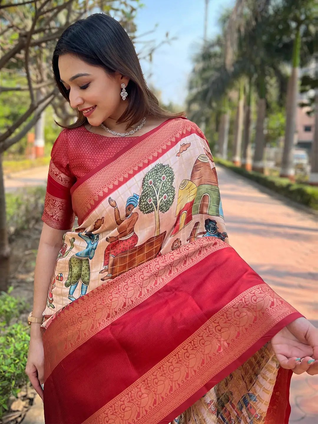 Close-up of red Banarasi saree with detailed artwork