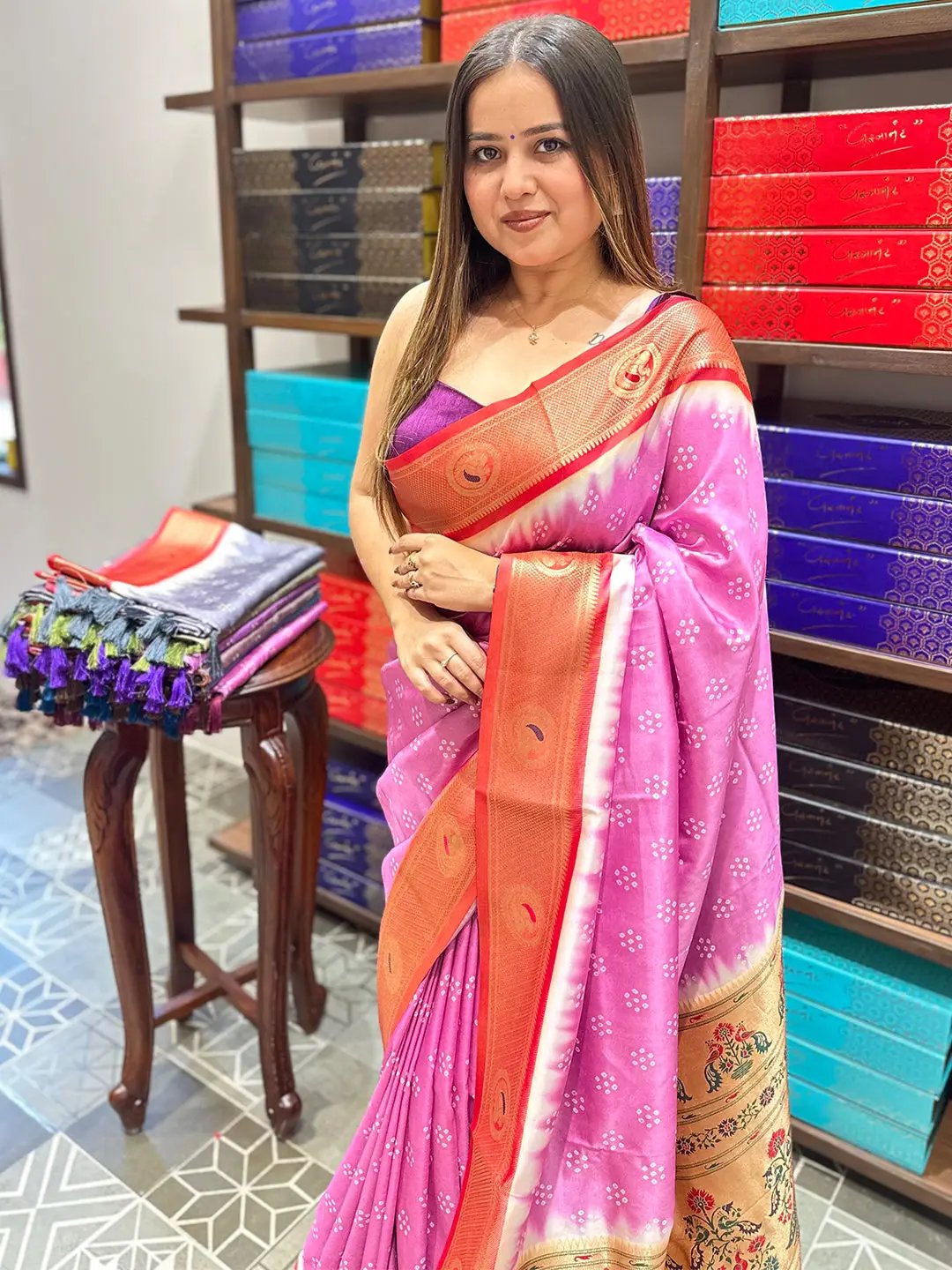 Pink Bandhani saree with Paithani border displayed in store